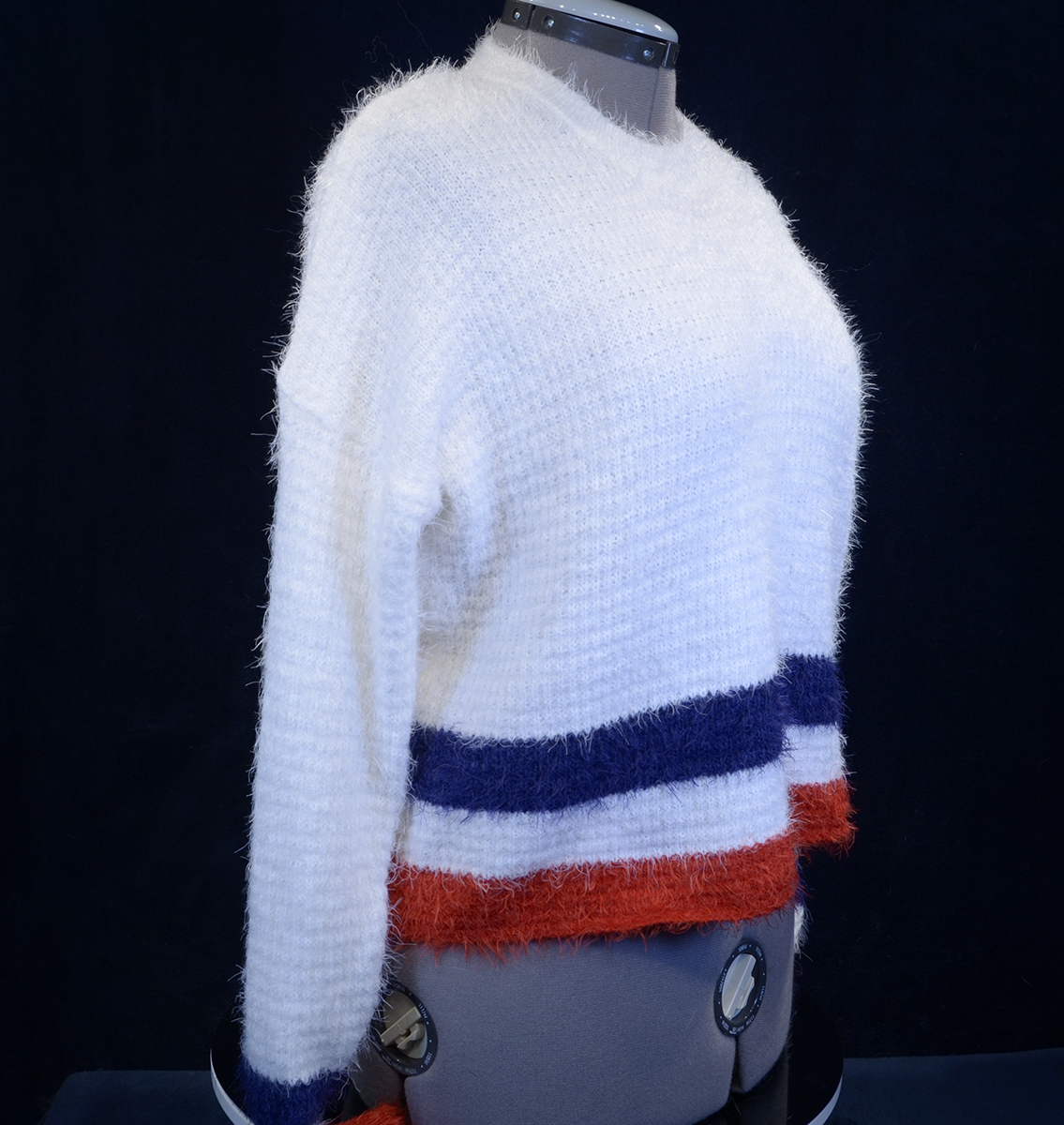 Woman's fuzzy white plush crewneck sweater with blue and red stripes on bottom and cuffs by Forever 21