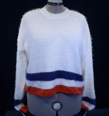 Woman's fuzzy white plush crewneck sweater with blue and red stripes on cuffs and bottom