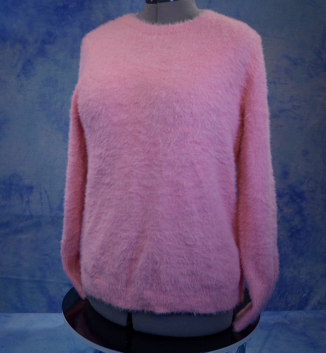 Girls's fuzzy pink plush crewneck sweater by Old Navy on mannequin against blue background