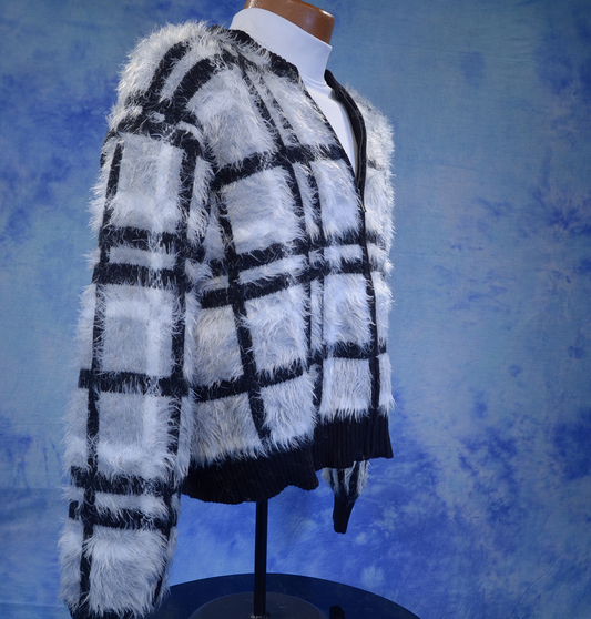 Woman's grey black and white plaid fuzzy eyelash cardigan sweater on mannequin