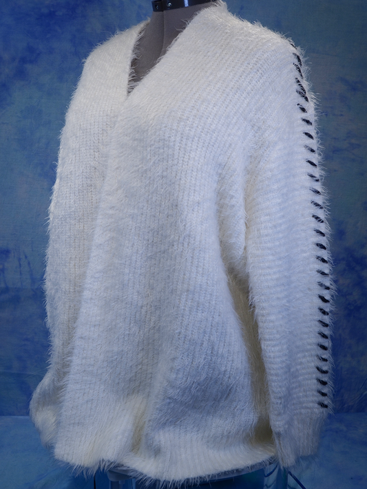 Woman's white eyelash open-front cardigan sweater with black hash marks along sleeves