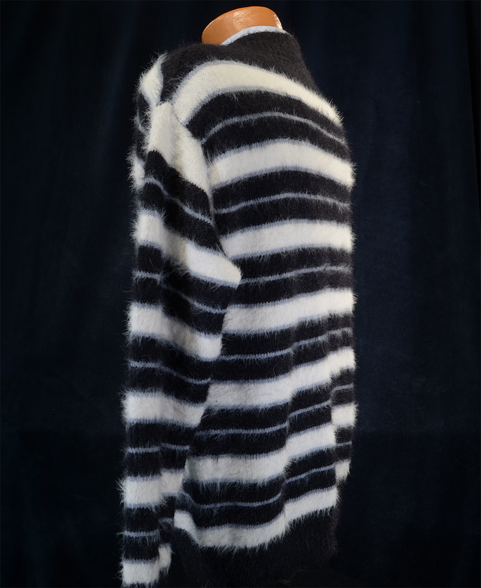 Men's striped fuzzy crewneck mohair sweater in black and white stripes on mannequin against dark background