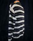 Men's striped fuzzy crewneck mohair sweater in black and white stripes on mannequin against dark background