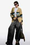 Fuzzy Open-Front Cardigan in tan with multi-colored horizontal stripes, made of soft fuzzy synthetic fibers, worn open without buttons.