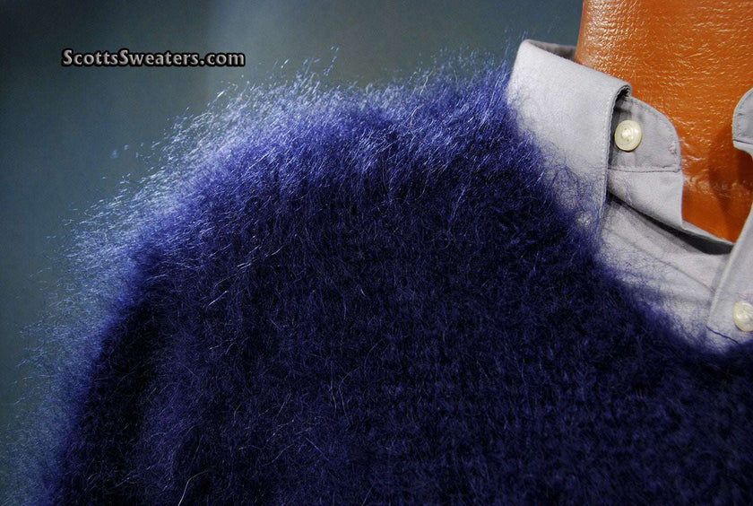 Close-up of extra soft navy blue men's kid mohair sweater with sheen over a light gray collared shirt.
