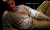 Man wearing extra soft hand-knit men's kid mohair sweater with beige and white stripes reclining against dark background