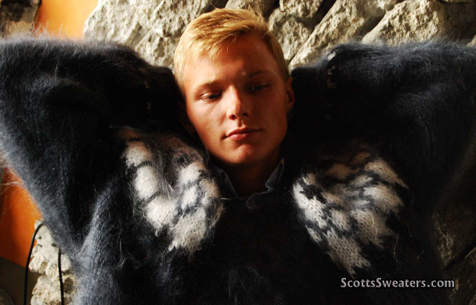 Man wearing handknit fuzzy black and white mohair cardigan men's sweater with zipper front