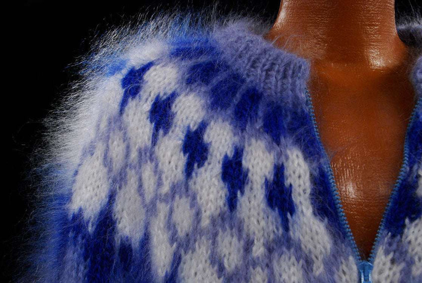 Close-up of hand-knit fuzzy mohair cardigan men's sweater in blue and white with zipper front