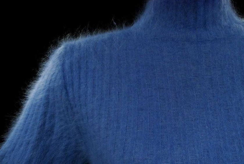 Woman's powder-blue rib-knit short-sleeved angora sweater size 32-34 with cling-fit design and stretch