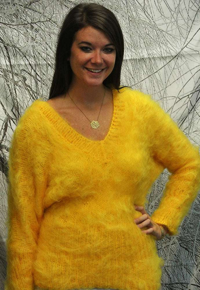 Woman wearing a fuzzy yellow hand-knit mohair double V-neck sweater by Scott's Sweaters