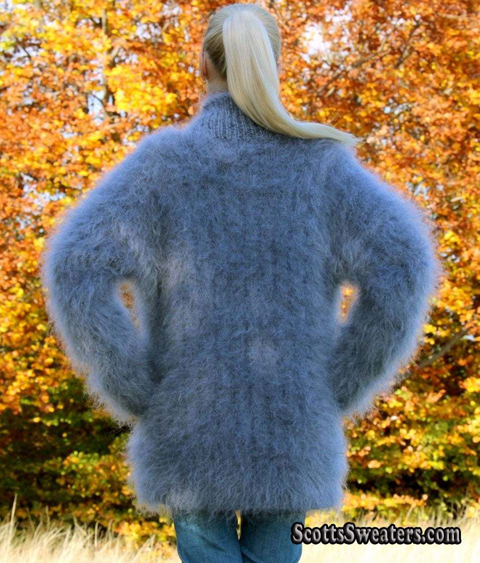 Unisex hand-knit mohair sweater with cross-over neck in blue worn outdoors in autumn leaves