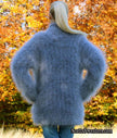 Unisex hand-knit mohair sweater with cross-over neck in blue worn outdoors in autumn leaves
