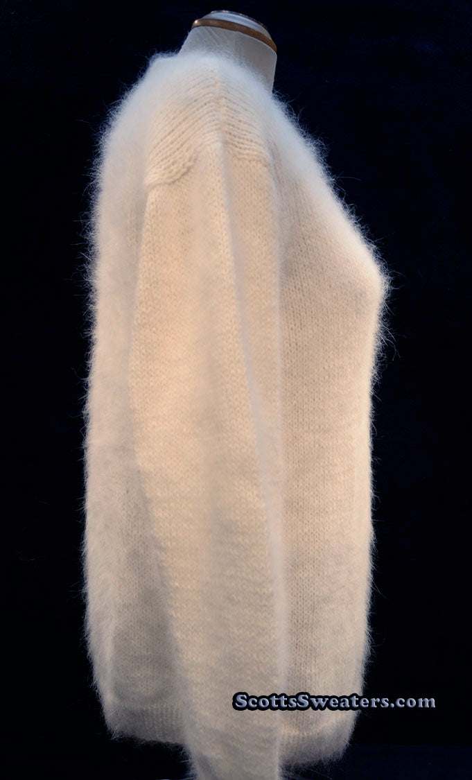 Woman wearing white hand-knit angora V-neck sweater by Scott's Sweaters, medium size.
