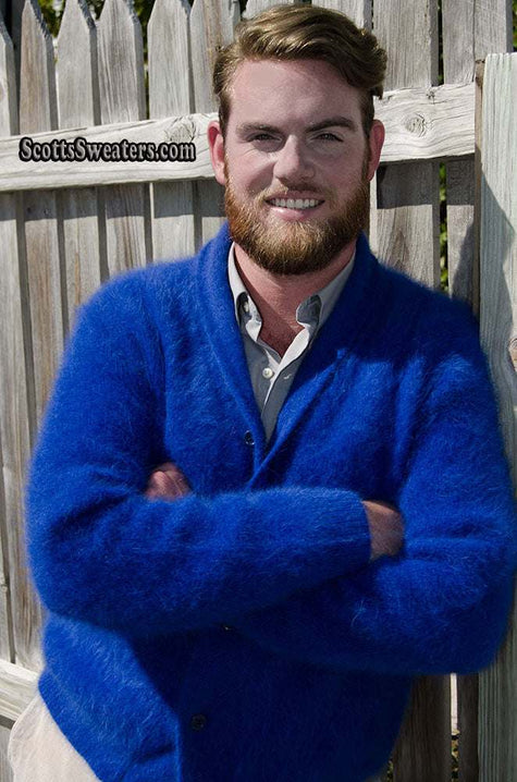 Man wearing royal-blue men's solid-color angora cardigan sweater with shawl-neck collar outdoors