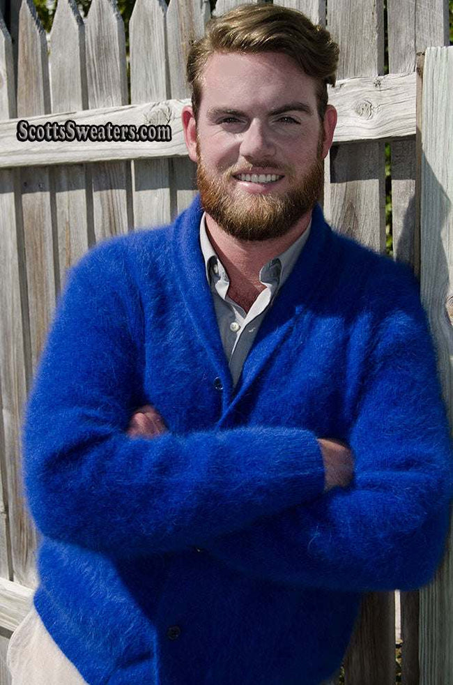 Man wearing royal-blue men's solid-color angora cardigan sweater with shawl-neck collar outdoors