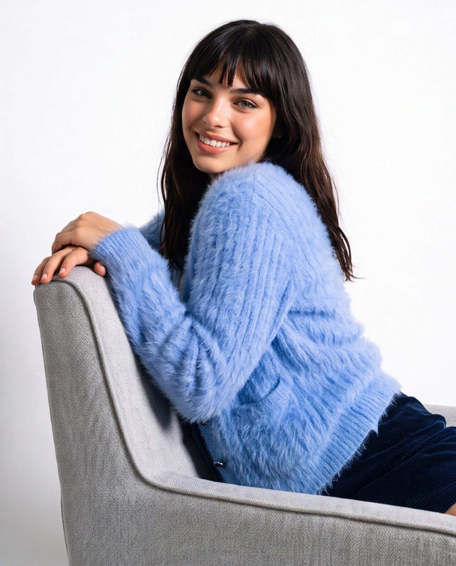 Woman's powder-blue angora cardigan sweater with subtle pockets and soft lightweight fabric