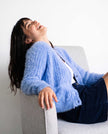 Woman's powder-blue angora cardigan sweater with pockets, soft and cozy women's knitwear for layering