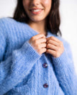 Woman's powder-blue angora cardigan sweater with subtle pockets and soft fabric for women's casual and polished looks