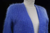 Woman wearing powder-blue angora cardigan sweater with pockets by Connie A. Lee