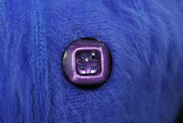 Woman wearing a powder-blue angora cardigan sweater with pockets by Connie A. Lee