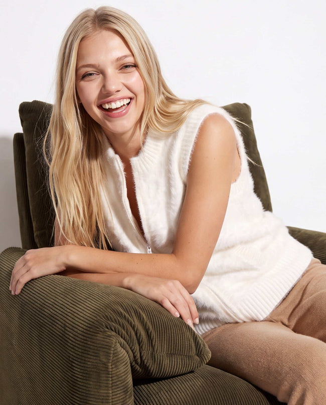 Woman's white angora zipper-front sweater vest with slash pockets and sleek silhouette