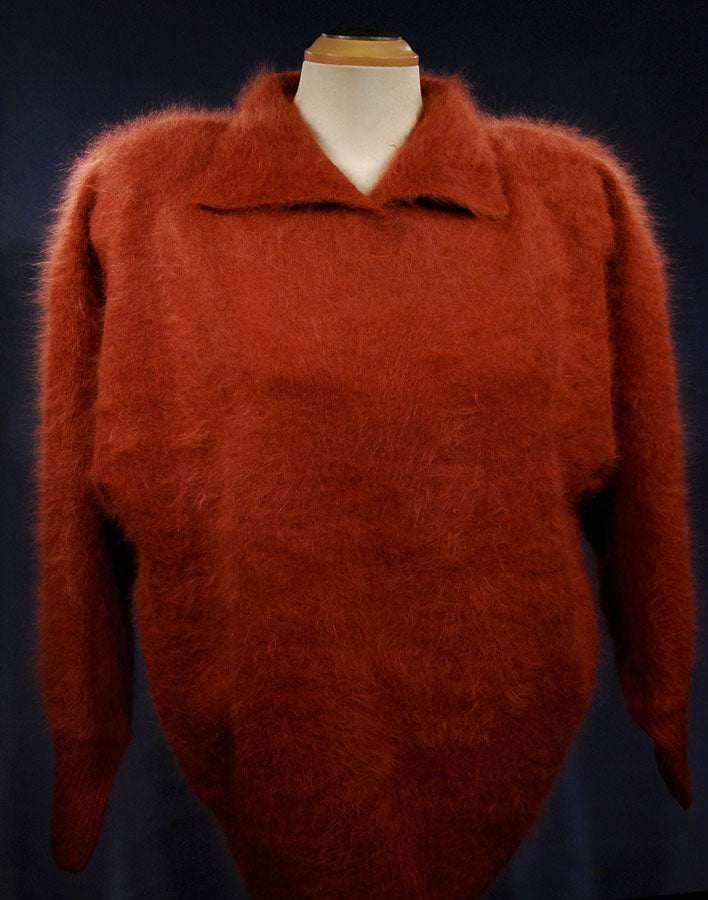 Woman's angora polo-neck sweater in rust color with long sleeves and fuzzy texture